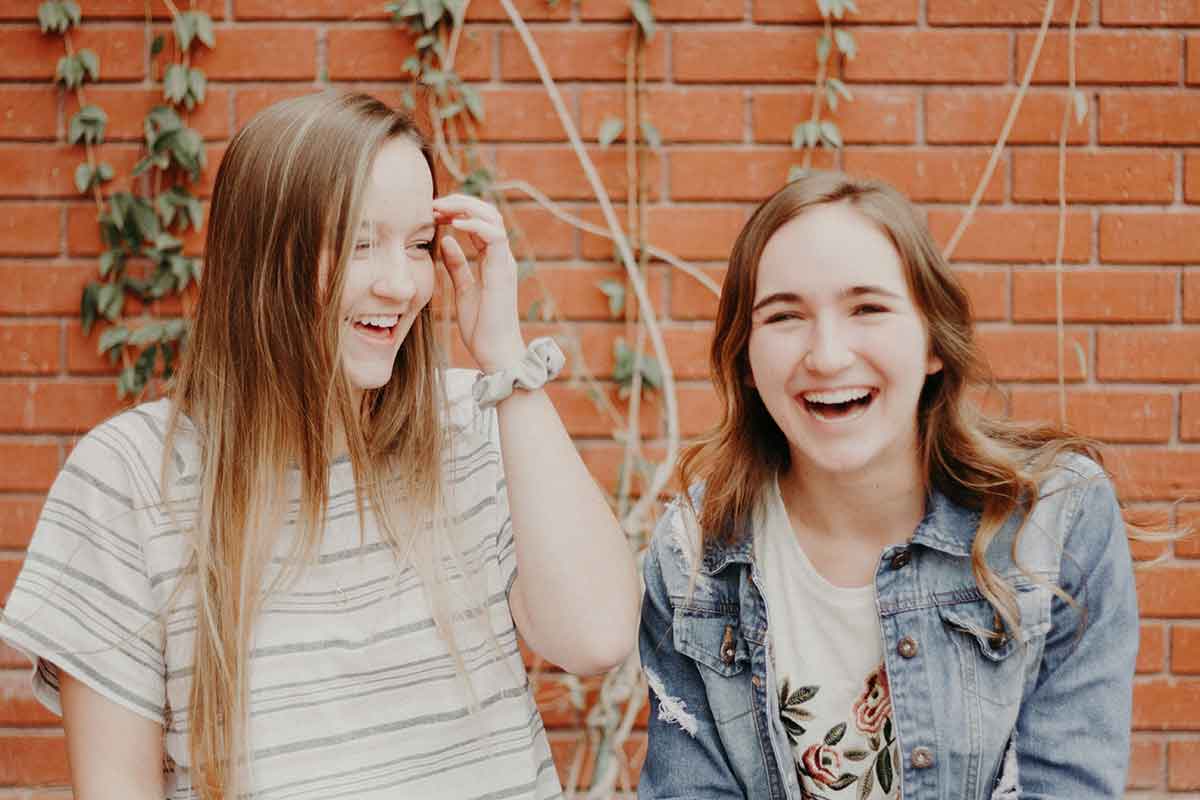 two young women laugh together